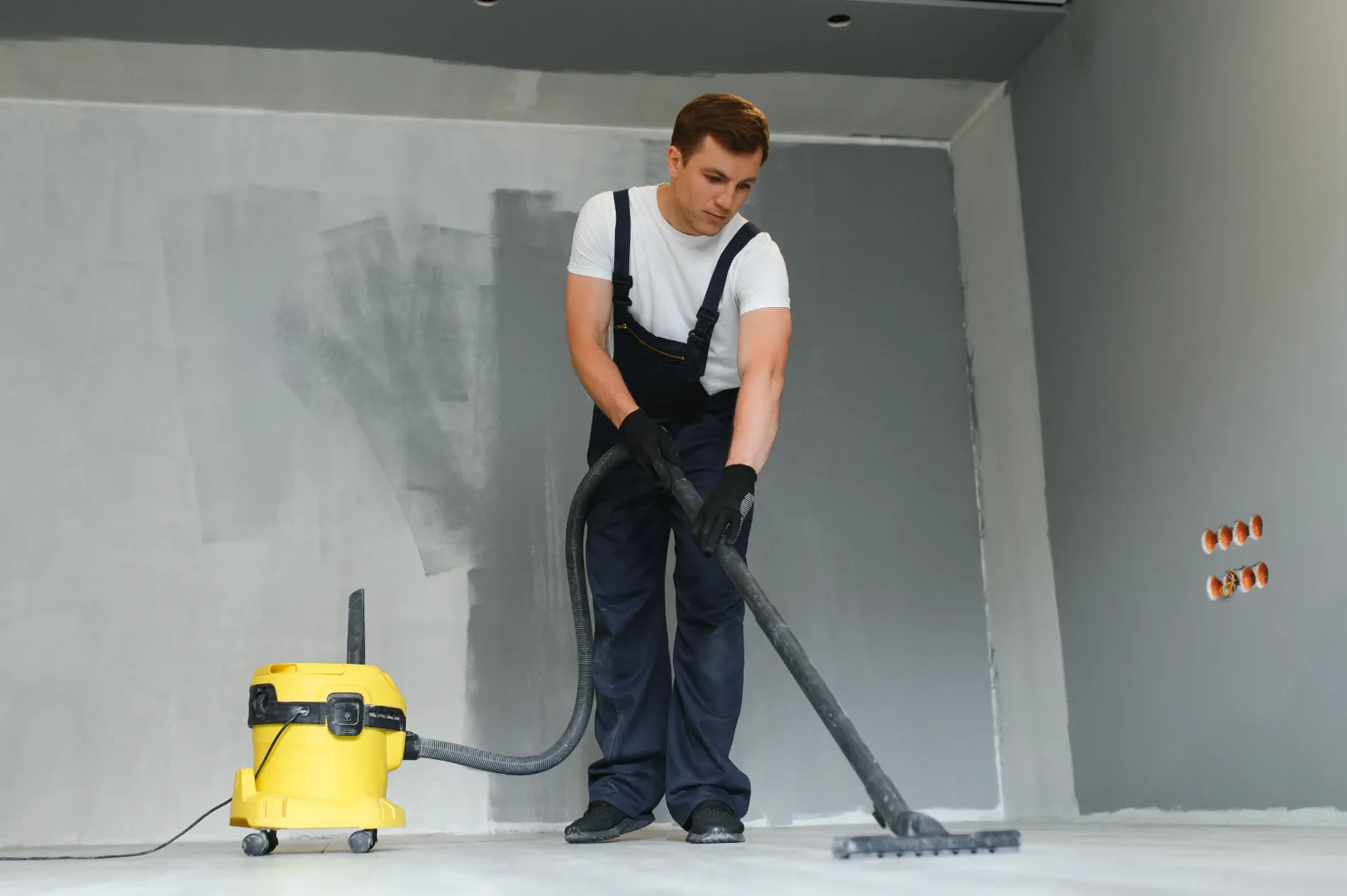 Professional removing construction dust with a vacuum